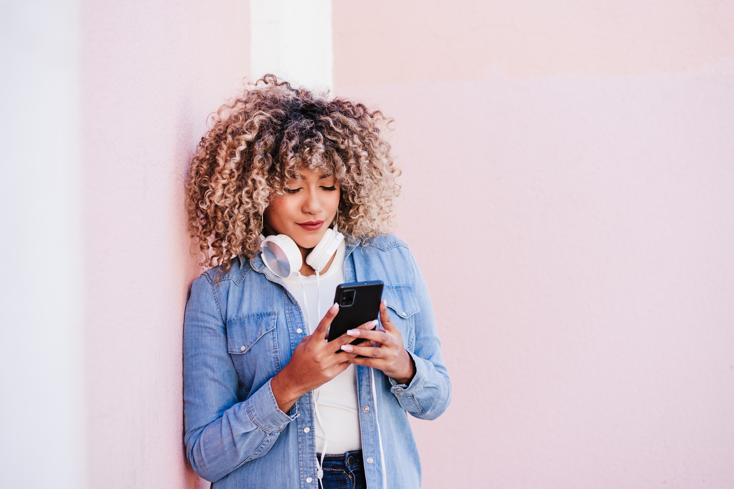 African american young woman searching for answers on her phone